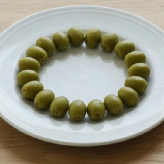 A close view of the plate after the center crop. The rim and the olives are still a circle