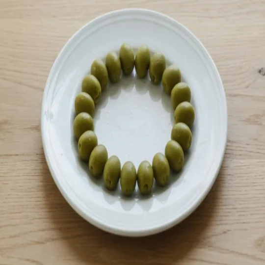 A close view of the plate after the square stretch. The rim and the olives form a tall ellipse